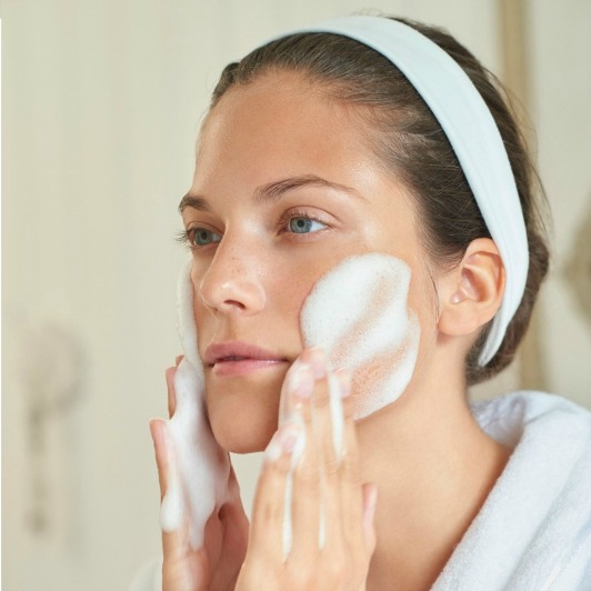 woman-cleansing-face-with-foam - Reflections Florida